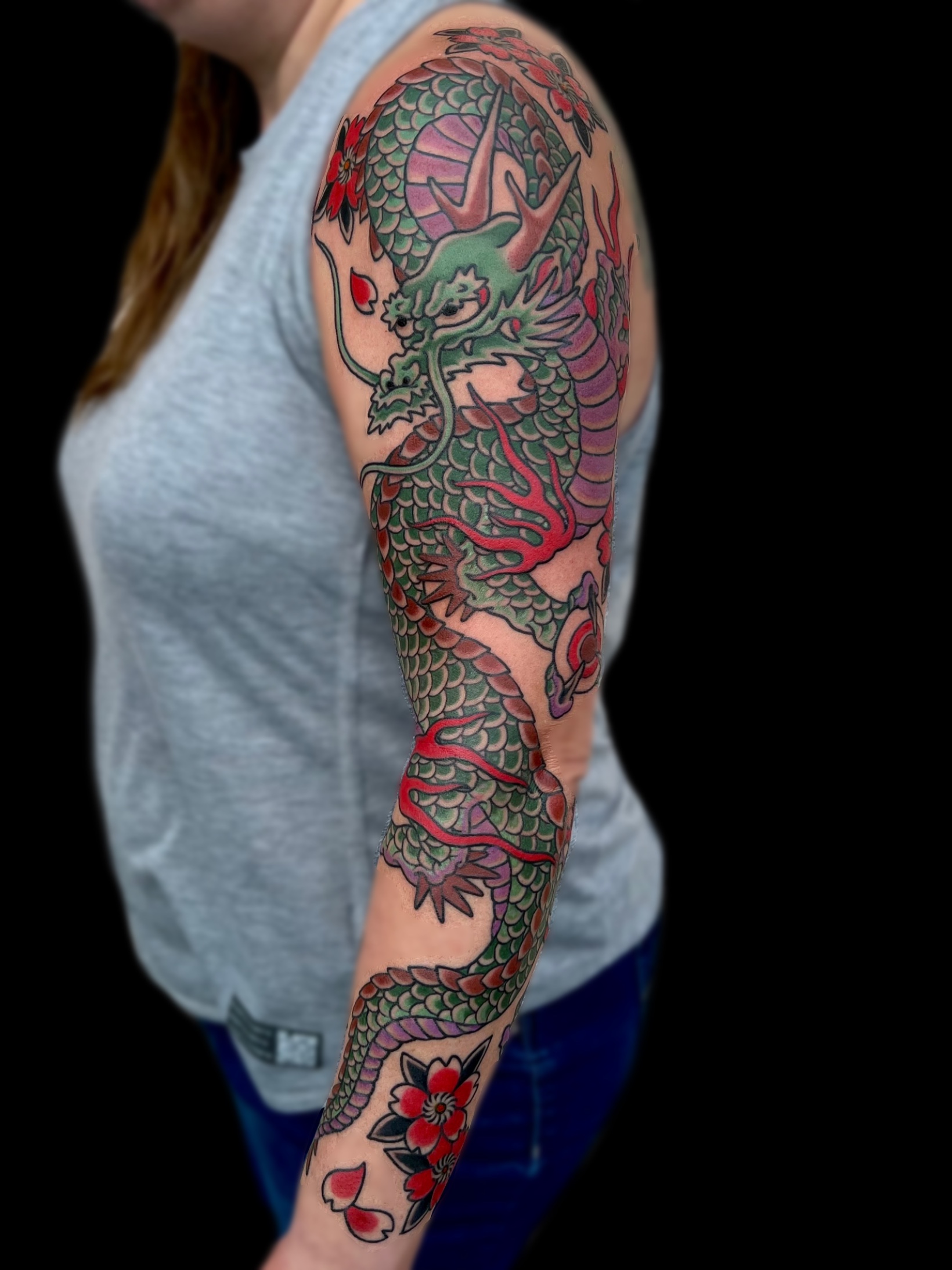 Traditional Japanese feminine dragon and cherry blossom full sleeve tattoo