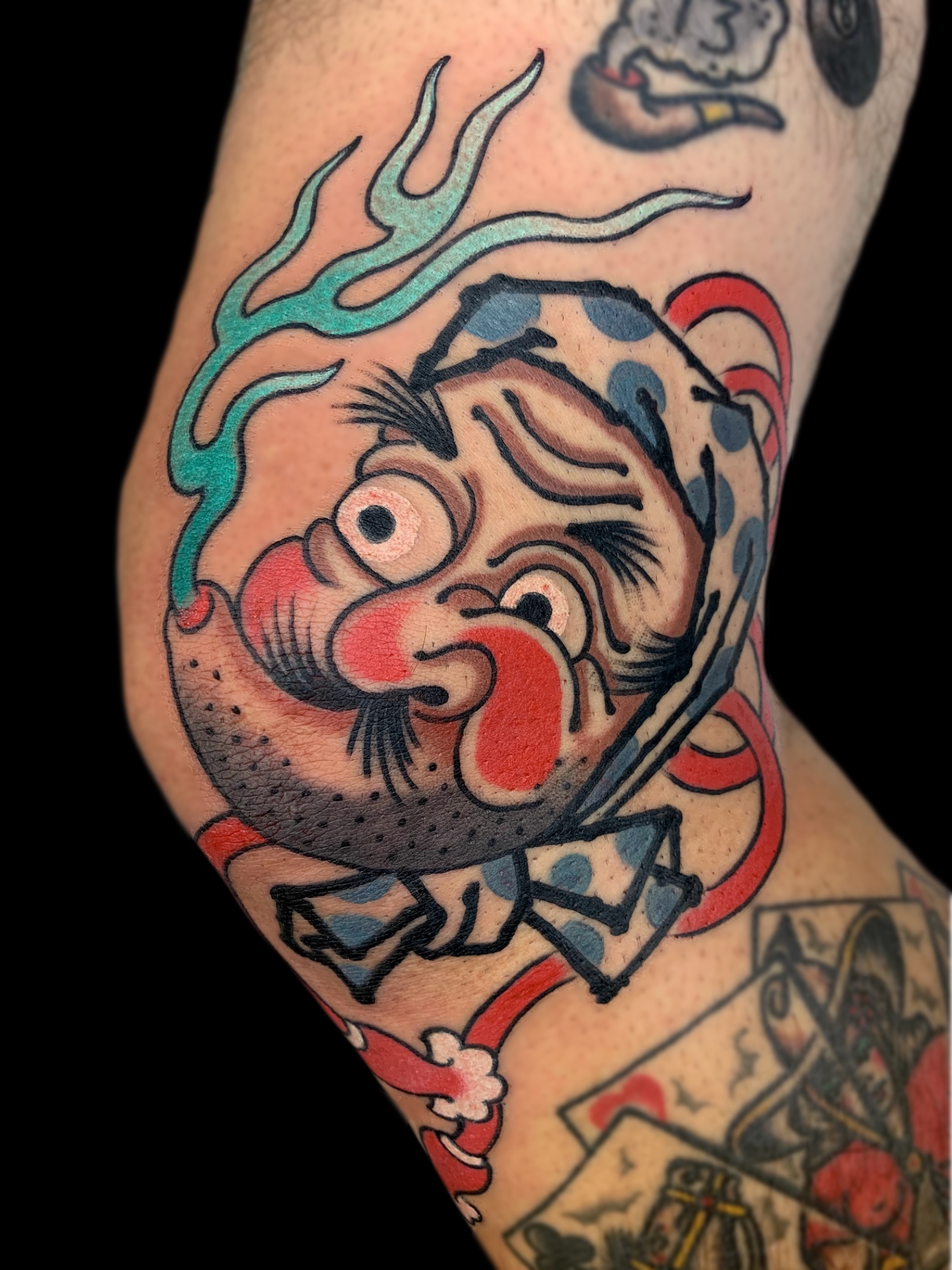 Traditional Japanese hyottoko leg tattoo